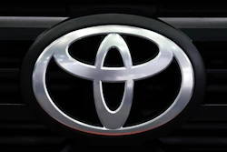 A Toyota logo is shown at the North American International Auto Show.
