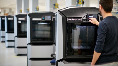 A worker receives advanced training on a Stratasys fused deposition modeling (FDM) 3D printer.