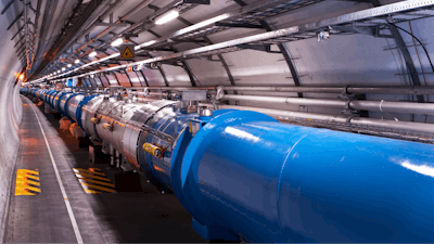 Particles rush through a long tunnel in the Large Hadron Collider.