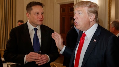 President Donald Trump, right, talks with Tesla and SpaceX CEO Elon Musk at the White House in Washington, Feb. 3, 2017.