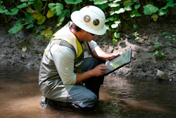 A Environmental Protection Agency worker works in Leslie Run in East Palestine, Ohio, June 12, 2024.