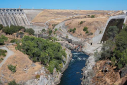 The American River flows out of the Folsom Dam, Friday, Aug. 16, 2024, in Folsom, Calif.