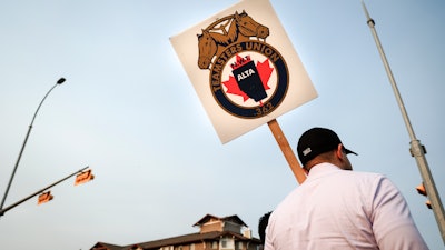Teamsters Canada Rail Conference members picket outside the CPKC headquarters in Calgary, Alta.