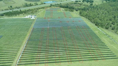Aerial photo of the solar panel field Hnaihen attacked with targeted panel areas outlined in red.