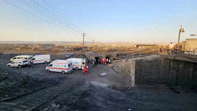 In this photo released by Iranian Red Crescent Society, ambulances stand at the site of a coal mine where methane leak sparked an explosion on Saturday, in Tabas, some 335 miles (540 kilometers) southeast of the capital Tehran, Iran, Sunday, Sept. 22, 2024.