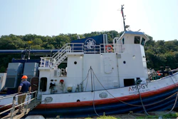 A worker stands near the NH3 Kraken, a tugboat powered by ammonia, on Friday, Sept. 13, 2024, in Kingston, N.Y.