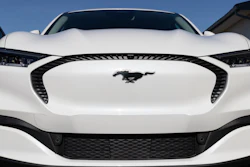 Ford Mustang Mach-E SUV display at a charging station.