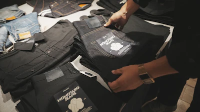 Shop clerk Yuta Akagi displays the jeans at Momotaro Jeans shop in Tokyo, on Sept. 18, 2024.