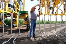 Jake Klocke, of PowerPollen, prepares a pollen applicator, Thursday, Aug. 22, 2024, near Ames, Iowa.