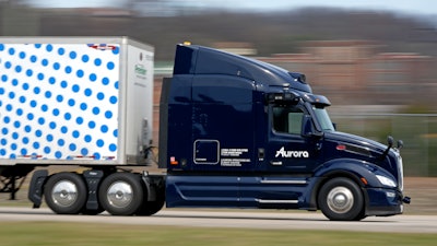 A self-driving tractor trailer maneuvers around a test track in Pittsburgh, Thursday, March 14, 2024. The truck is owned by Pittsburgh-based Aurora Innovation Inc.