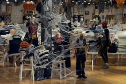 A woman shops at a fashion boutique decorated with Halloween in Beijing, Thursday, Oct. 31, 2024.
