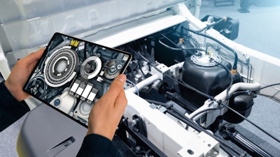 Digital tablet under the hood of a vehicle.