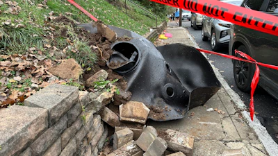 A large metal piece of debris that was flung across a street by a blast at a Louisville, Ky, plant is shown on Wednesday, Nov. 13, 2024. Two workers died in the explosion at the Givaudan Color Sense plant in Louisville.