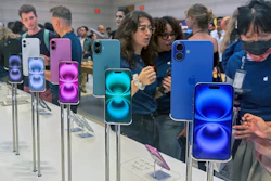 People gather near a display of iPhone 16's at the Apple Store on 5th Ave. in New York on September 20, 2024.