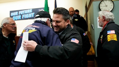 IAM District 751 president Jon Holden greets union members after announcing they voted to accept a new contract offer from Boeing, Monday, Nov. 4, 2024, at their union hall in Seattle.