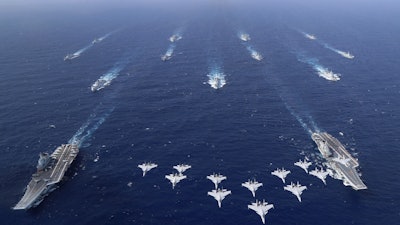 In this photo released by Xinhua News Agency, conventionally powered Chinese aircraft carriers Liaoning and Shandong carry out a dual aircraft carrier formation exercise for the first time in the South China Sea in late October 2024.