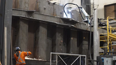 At Carriere Industrial Supply (CIS), a human welder and a robotic welder work side-by-side, leap-frogging across the side of the truck body to double output.
