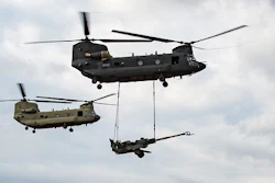 A U.S. Army CH-47F Block II Chinook conducts a sling load test alongside a CH-47F Block I aircraft.