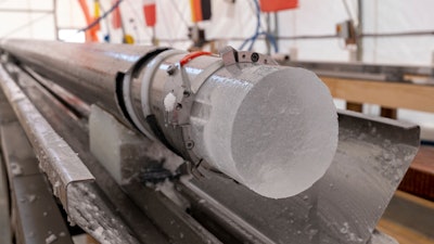 An ice core drilled by a research team is displayed at Little Dome C field base in eastern Antarctica, during the cutting phase on Tuesday, Jan. 7, 2025.