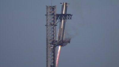 SpaceX's mega rocket Starship booster returns to the launch pad during a test flight from Starbase in Boca Chica, Texas, Thursday, Jan. 16, 2025.