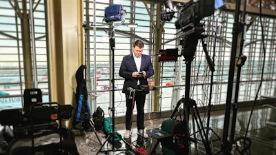 This April 2023 image released by CNN shows aviation correspondent Pete Muntean preparing for a live broadcast at Reagan National Airport in Washington.
