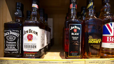 In this July 7, 2018, file photo, whiskeys distilled and bottled in the U.S. are displayed for sale in a grocery store in Beijing.