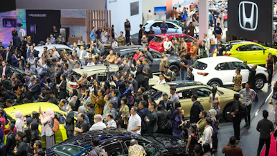 Visitors look at vehicles during the Indonesian International Motor Show in Jakarta, Indonesia, Thursday, Feb. 13, 2025.