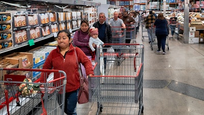 Customers wait in line for eggs at a Costco store in the Van Nuys section of Los Angeles, Feb. 19, 2025.