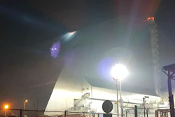 In this photo provided by the Ukrainian Emergency Service, a searchlight illuminates the damages of a protective shell over the fourth reactor of the Chernobyl nuclear power plant following a drone strike, Friday, Feb. 14, 2025.