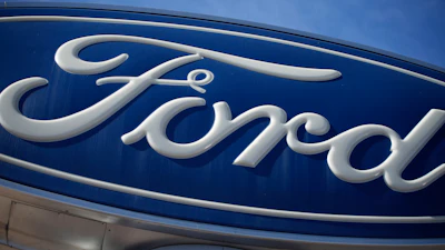 The Ford company logo is seen, Oct. 24, 2021, on a sign at a Ford dealership in southeast Denver.