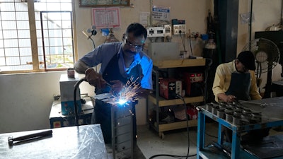 A worker welds a steel chassis at a factory in a suburb of Bengaluru, India, Thursday, Feb. 27, 2025.