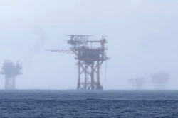 Oil platforms are visible through the haze near the Flower Garden Banks National Marine Sanctuary in the Gulf of Mexico, off the coast of Galveston, Texas, Saturday, Sept. 16, 2023.