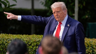 President Donald Trump gestures to the crowd as he departs after welcoming the 2025 College Football National Champions, the Ohio State University football team, during an event on the South Lawn of the White House, Monday, April 14, 2025, in Washington.