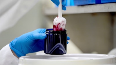 Technician Heather Browning packages a color sample made of beet powder at Sensient Technologies Corp., St. Louis., April 2, 2025.