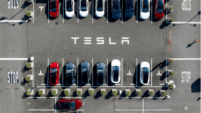 Tesla vehicles line a parking lot at the company's Fremont, Calif., factory on Sept. 18, 2023.