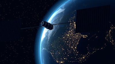 A satellite flying above earth.