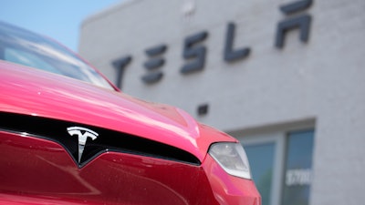A Model X sports-utility vehicle sits outside a Tesla store in Littleton, Colo., June 18, 2023.