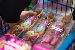 A collection of Barbie dolls are placed into a cart in Bowling Green, Ky., on Tuesday, Dec. 7, 2021.