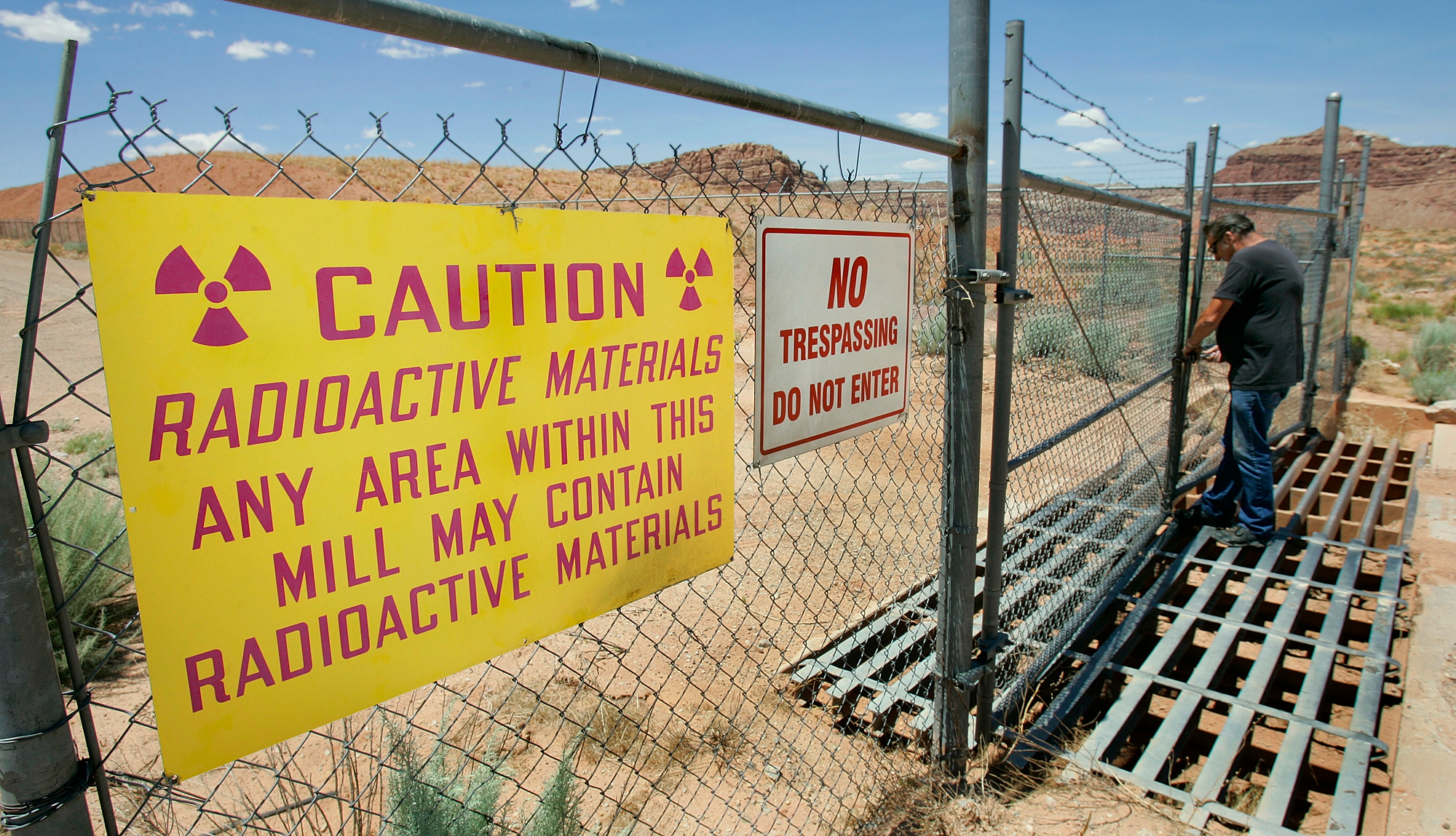 U.S. Energy Corp. resident project manager Daryl Winters locks the gate, on July 12, 2006, at the Shootaring Mill north of Ticaboo, Utah.