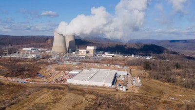 A data center owned by Amazon Web Services, front right, is under construction next to the Susquehanna nuclear power plant in Berwick, Pa., on Tuesday, Jan. 14, 2024.