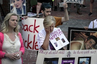 Protesters who have lost love ones to the opioid crisis protest outside a courthouse in Boston, Aug. 2, 2019, where a judge heard arguments in a lawsuit against Purdue Pharma.