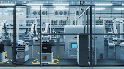 High-tech automated manufacturing facility with robotic arms and control systems.