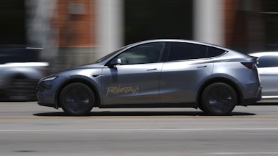 A driverless Tesla robotaxi, a ride-booking service, moves through traffic, Sunday, June 22, 2025, in Austin, Texas.