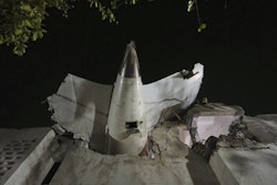 The tail of the airplane is seen stuck in a building at the site of an airplane that crashed in India's northwestern city of Ahmedabad in Gujarat state, June 12, 2025.