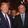 Brazil's President Jair Bolsonaro, right, stands with President Donald Trump during a dinner at Mar-a-Lago, Palm Beach, Fla., March 7, 2020.