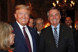 Brazil's President Jair Bolsonaro, right, stands with President Donald Trump during a dinner at Mar-a-Lago, Palm Beach, Fla., March 7, 2020.