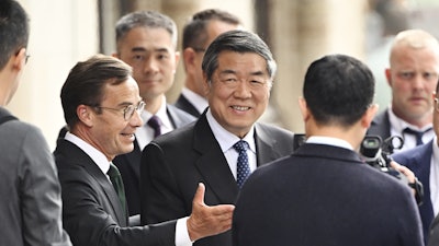 Swedish prime minister Ulf Kristersson, center left, gestures as he greets Chinese vice prime minister He Lifeng, center, at Rosenbad before trade talks between the US and China in Stockholm, Sweden, July 28, 2025.