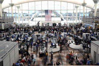 Passengers wait in a security line at Denver International Airport on Feb. 22, 2023.