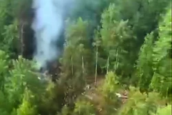 In this photo taken from video released by Russia Emergency Situations Ministry press service on Thursday, July 24, 2025, smoke rises from the crash site of a Russian An-24 passenger plane of the Siberia-based Angara Airlines about 15 kilometers (9 miles) south of Tynda, Far Eastern Amur region of Russia.