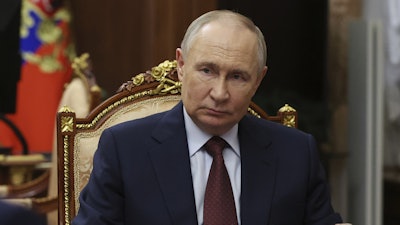 Russian President Vladimir Putin listens to Russian Academy of Sciences President Gennady Krasnikov during their meeting at the Kremlin in Moscow, Russia, Tuesday, July 15, 2025.